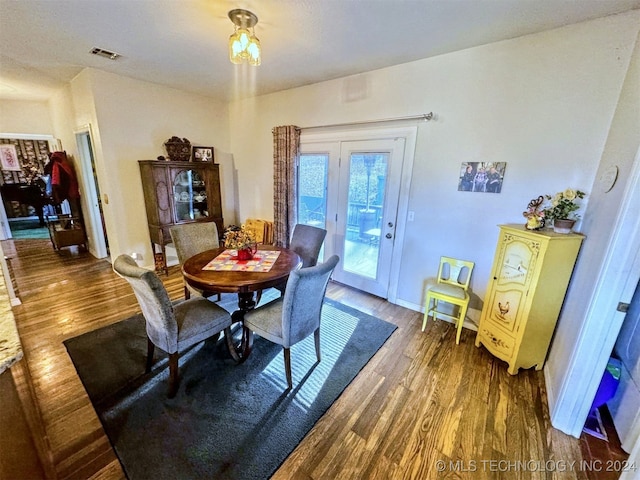 dining area with dark hardwood / wood-style flooring