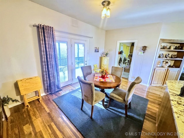 dining area with washer and clothes dryer and dark wood-type flooring