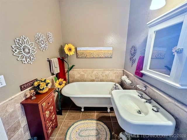 bathroom featuring a tub, tile patterned flooring, and tile walls