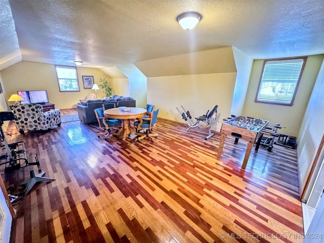 rec room with hardwood / wood-style floors, a textured ceiling, and plenty of natural light