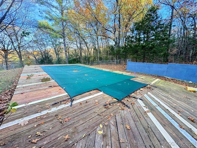 view of swimming pool with a wooden deck