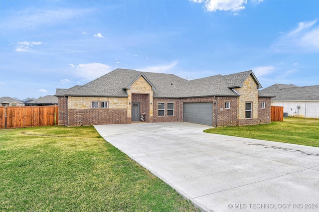 view of front of property with a front yard and a garage