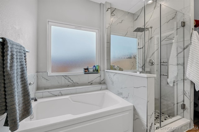 bathroom with shower with separate bathtub