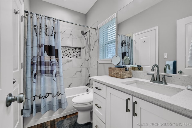 full bathroom featuring toilet, vanity, hardwood / wood-style flooring, and shower / tub combo with curtain