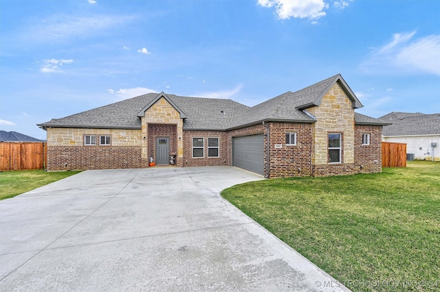 view of front of house with a front yard and a garage