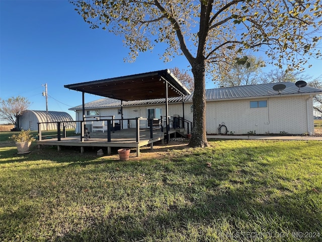 back of house featuring a yard and a deck