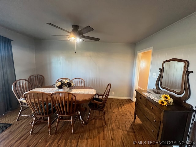 dining area featuring ceiling fan and dark wood-type flooring