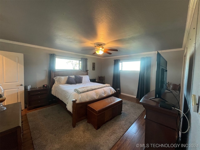 bedroom with a textured ceiling, multiple windows, ceiling fan, and dark hardwood / wood-style floors