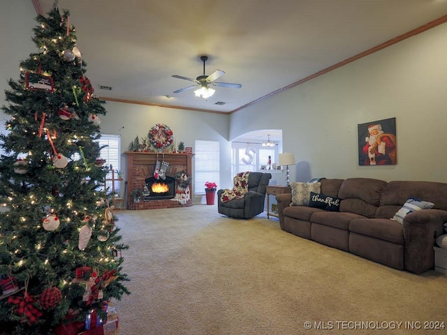 carpeted living room featuring a fireplace, ceiling fan, and crown molding