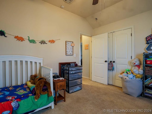 carpeted bedroom with vaulted ceiling, a closet, and ceiling fan