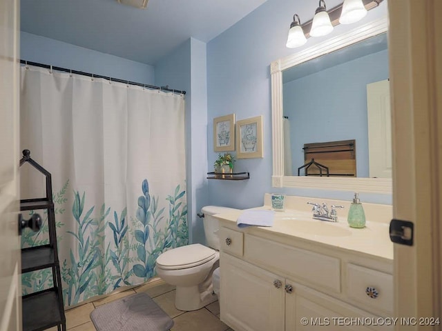 bathroom with tile patterned floors, vanity, curtained shower, and toilet