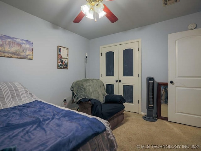 carpeted bedroom with ceiling fan, a closet, and french doors