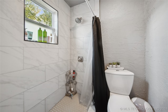 bathroom with toilet and curtained shower