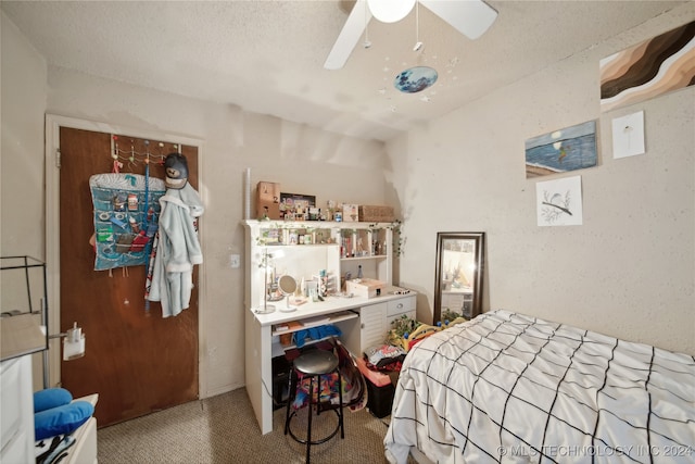 bedroom featuring ceiling fan, carpet, and a textured ceiling