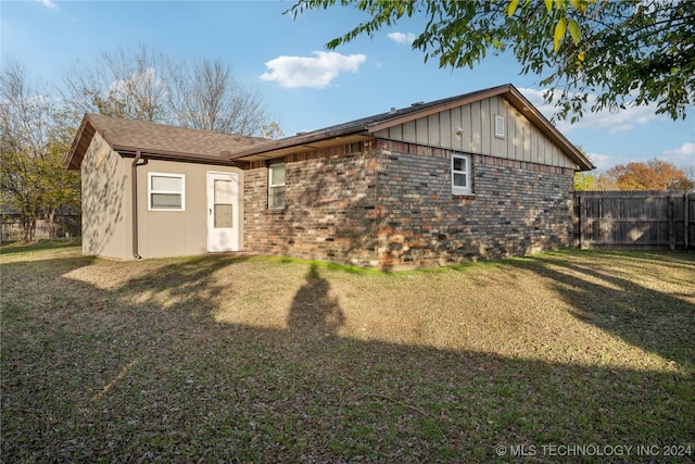 back of house with a yard