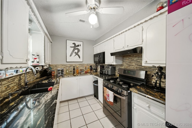 kitchen featuring white cabinets, a textured ceiling, stainless steel gas range oven, and sink