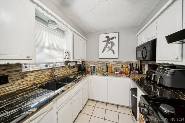 kitchen featuring white cabinetry, stainless steel range, sink, tasteful backsplash, and a textured ceiling