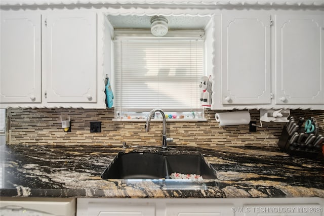 kitchen featuring sink and white cabinets