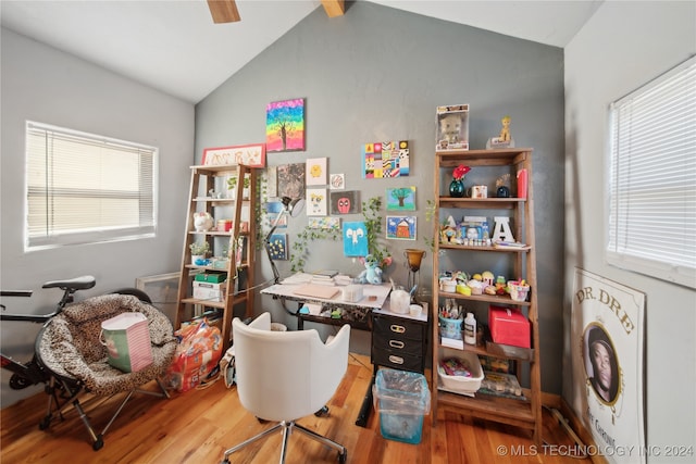 office with hardwood / wood-style floors and vaulted ceiling with beams