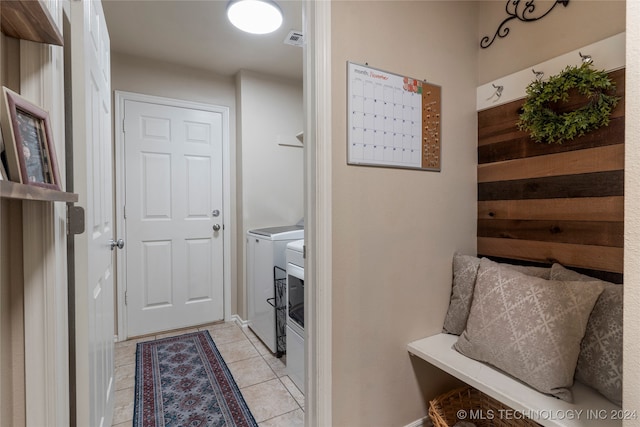 interior space with separate washer and dryer and light tile patterned flooring