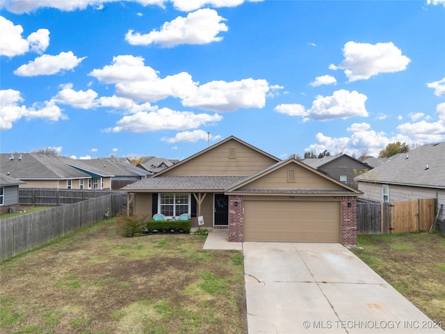 ranch-style house with a garage and a front lawn