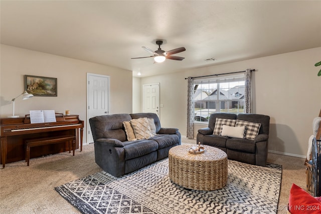 carpeted living room with ceiling fan