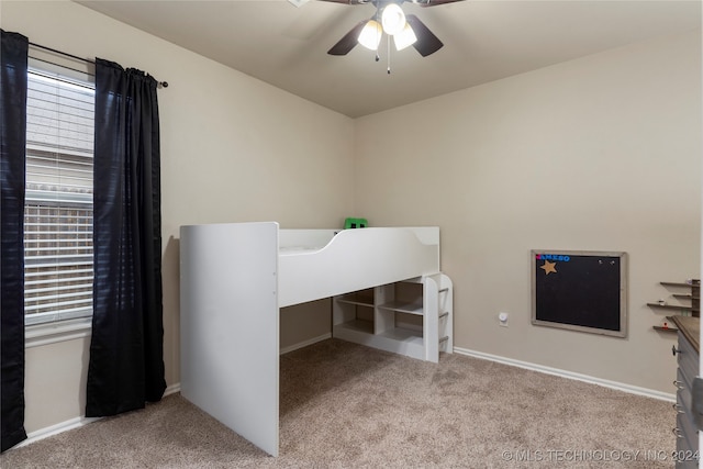 unfurnished bedroom with ceiling fan and light carpet