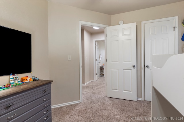 bedroom featuring light carpet