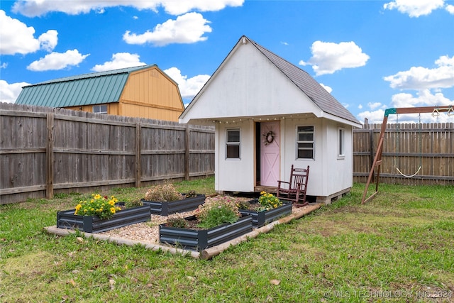 rear view of house featuring a yard and a storage shed