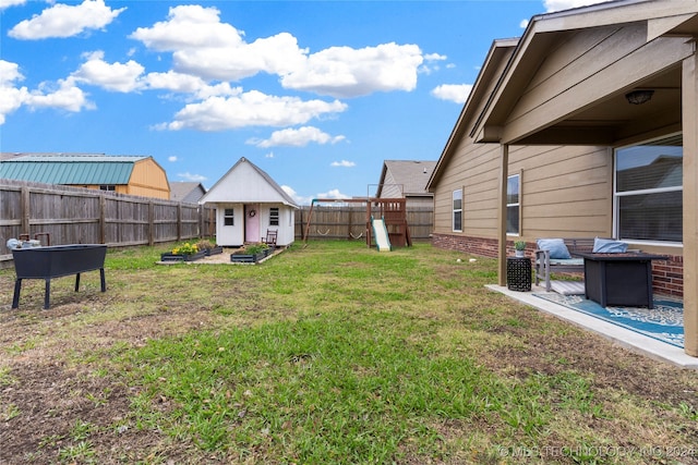 view of yard with an outdoor structure and a playground