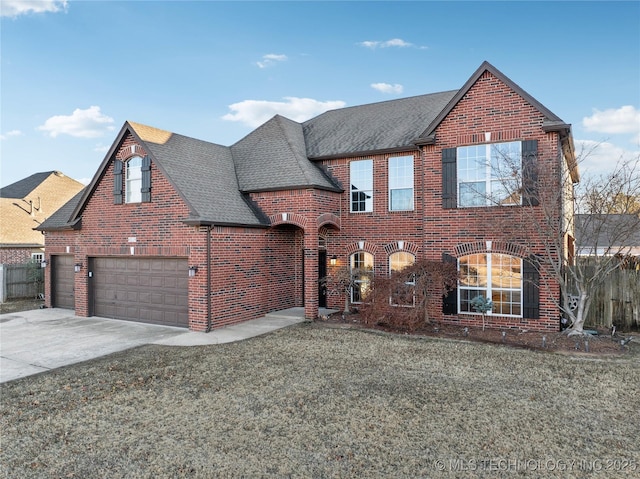 view of front of property featuring a front lawn and a garage