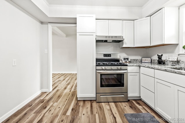 kitchen with gas stove, light stone countertops, light hardwood / wood-style flooring, and white cabinets