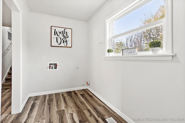 laundry area featuring crown molding, wood-type flooring, and washer hookup