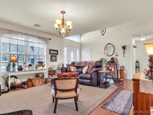 living room featuring light hardwood / wood-style floors and a chandelier