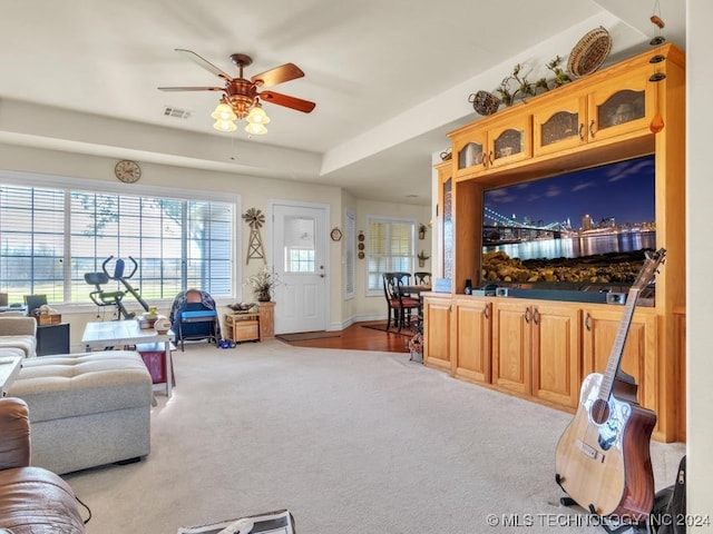 carpeted living room with ceiling fan