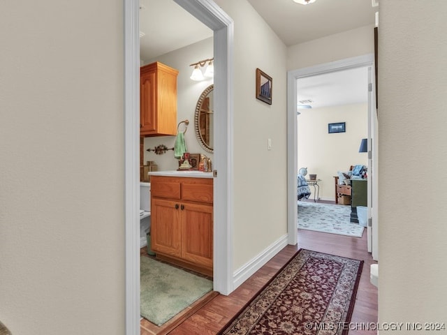 hall featuring sink and hardwood / wood-style flooring