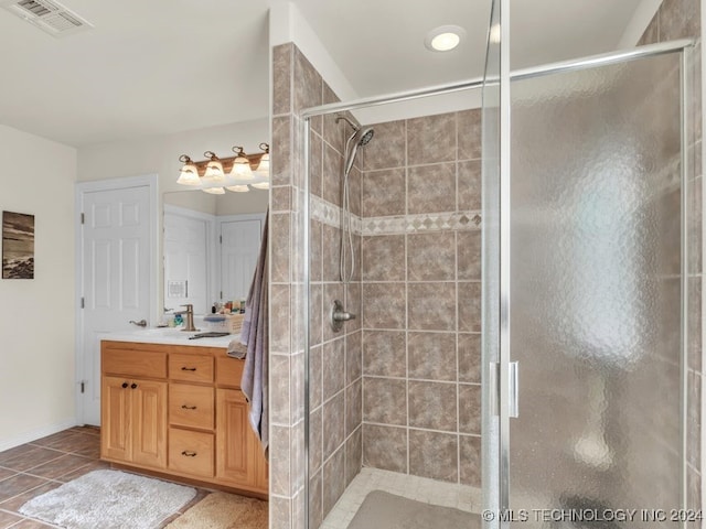 bathroom with vanity, tile patterned floors, and walk in shower