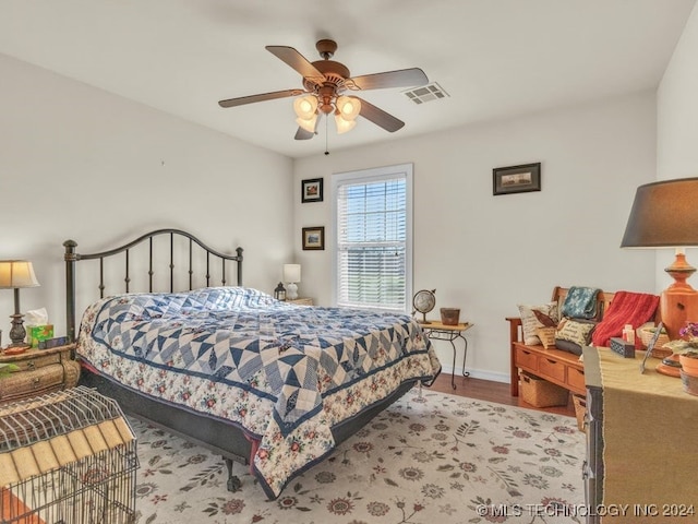 bedroom with ceiling fan and light hardwood / wood-style floors