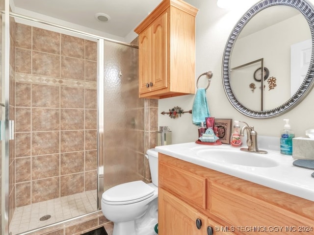 bathroom with vanity, toilet, and walk in shower