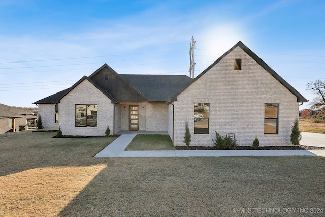 french country home featuring a front yard