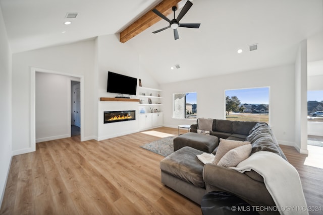 living room with beam ceiling, light hardwood / wood-style floors, high vaulted ceiling, and ceiling fan