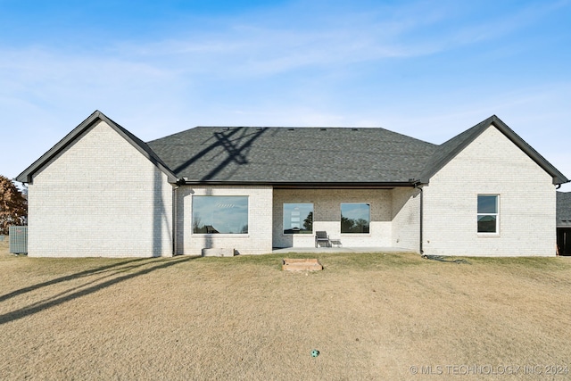 rear view of house featuring a yard