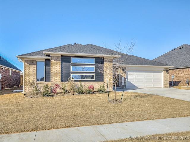 view of front of house with a garage and a front lawn