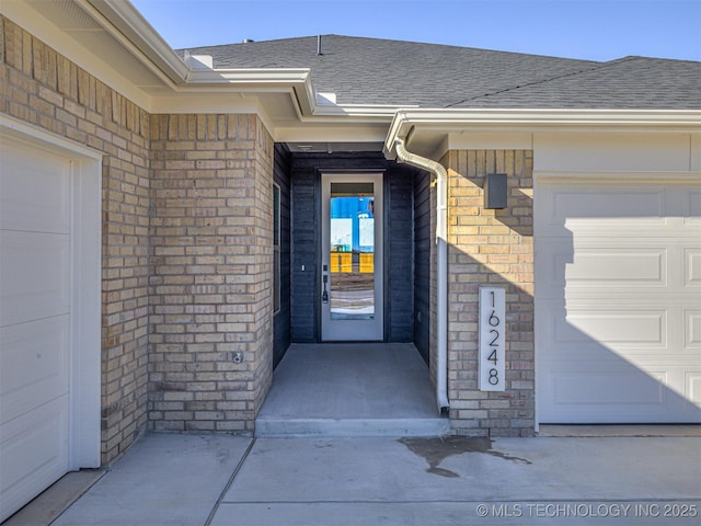 doorway to property with a garage