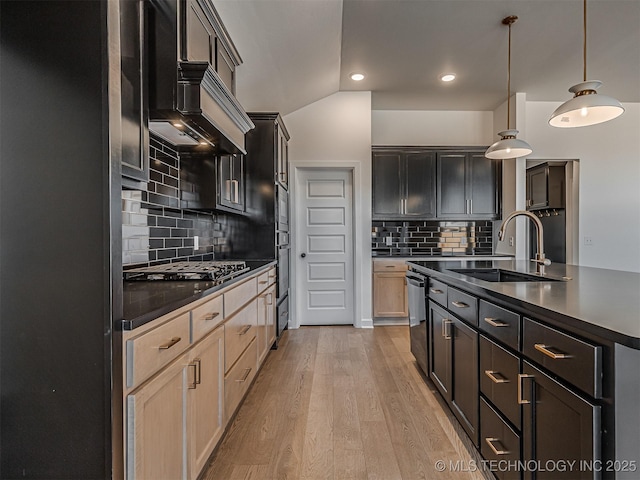 kitchen featuring sink, light hardwood / wood-style flooring, light brown cabinetry, decorative backsplash, and stainless steel gas stovetop