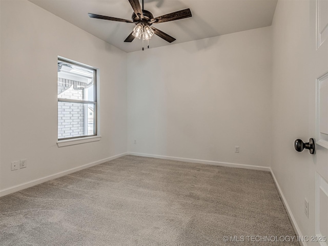 carpeted spare room with ceiling fan