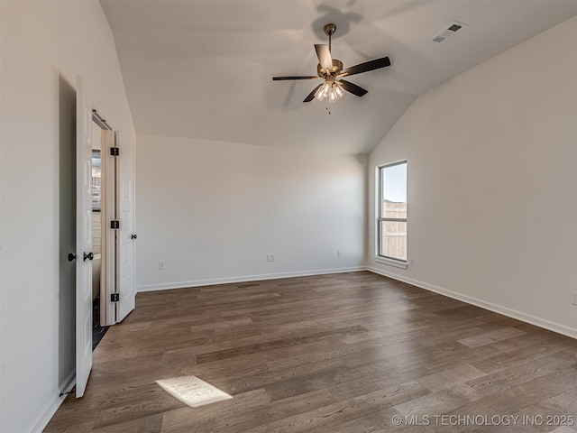 spare room with dark hardwood / wood-style flooring, lofted ceiling, and ceiling fan