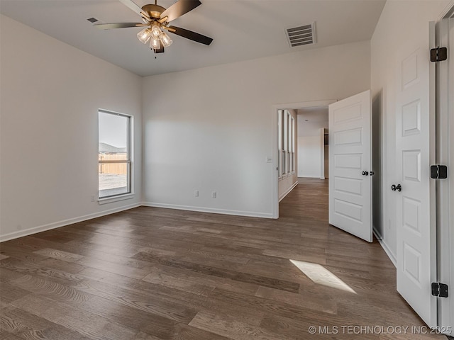 unfurnished room featuring ceiling fan and dark hardwood / wood-style flooring