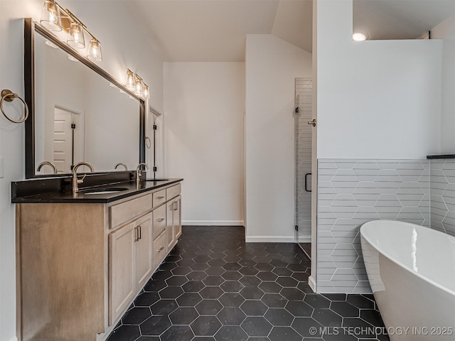 bathroom featuring tile patterned flooring, vanity, independent shower and bath, and tile walls