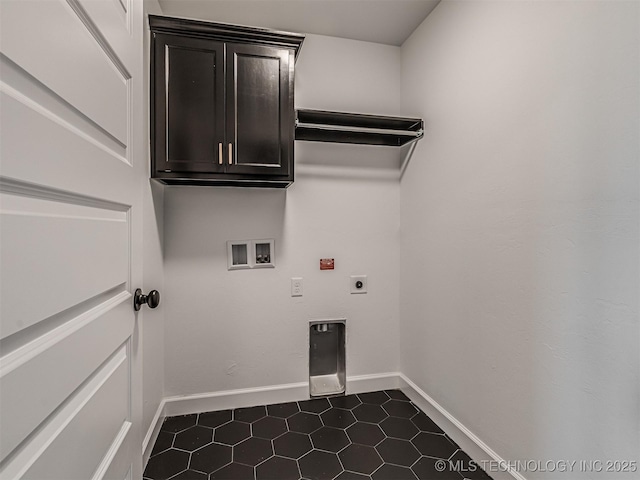 laundry room with hookup for a washing machine, electric dryer hookup, dark tile patterned floors, and cabinets